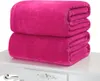 Two folded pink fleece blankets stacked on a white table. Produktbild-Vorschau