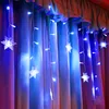 Blue snowflake string lights are draped over a curtain, creating a festive atmosphere. Náhled obrázku produktu