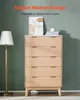 A modern dresser with a textured wood finish is displayed in a room with a floor lamp and artwork. Voir les images du produit