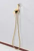 A gold bidet spray set mounted on a textured wall. Produktbild-Vorschau