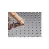 A close-up of a finger touching a shower head with water droplets. Produktbild-Vorschau