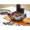 A Halloween-themed candy bowl filled with assorted candies, placed on a table with a candle and a pumpkin-shaped placemat. Produktbild-Vorschau