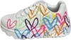 A white sneaker with colorful heart drawings. Voir les images du produit
