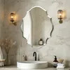 A modern bathroom vanity with a unique mirror, sink, and faucet. Anteprima dell’immagine prodotto