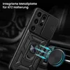 A black phone case with a ring holder is shown attached to a car vent with a magnetic mount. The case has a sliding camera cover and a rugged design. Produktbild-Vorschau