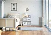 A child's bedroom with a bed, toys, and an air purifier. Podgląd zdjęcia produktu