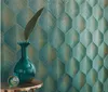 A vase with a leaf on a table against a patterned wallpaper. Podgląd zdjęcia produktu
