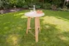 A wooden bar table with drinks and fruit set up on a grassy lawn in a garden. Produktbild-Vorschau