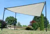 A beige canopy tent is set up in a grassy yard with trees and a wooden fence in the background. Produktbild-Vorschau