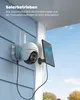 A solar-powered security camera mounted on a blue-sided house, connected to a solar panel. Náhled obrázku produktu