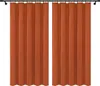 Two orange curtains hanging on a curtain rod against a white background. Podgląd zdjęcia produktu