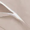 A close-up view of a zipper on a taupe fabric. Produktbild-Vorschau