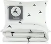A white pillow and folded duvet cover with a repeating pattern of black deer silhouettes, presented on a white background. Produktbild-Vorschau