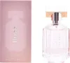 A pink box and a clear glass perfume bottle with a gold cap. Produktbild-Vorschau