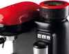 Close-up of a red and black espresso machine with a coffee grinder. Produktbild-Vorschau