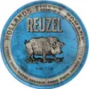 A circular tin of Reuzel pomade with a pig illustration. Produktbild-Vorschau