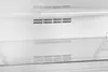 Inside view of a white refrigerator with shelves and vents. Produktbild-Vorschau