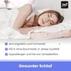A woman sleeping peacefully in bed, with text overlays highlighting product features. Produktbild-Vorschau