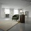 A modern living room or gallery space with a green armchair, a wooden pedestal, a lamp, books, and artwork. Anteprima dell’immagine prodotto