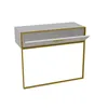 A white and gold console table with a drawer slightly ajar.