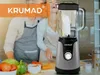 A couple is in a kitchen preparing food, with a blender prominently displayed in the foreground. Produktbild-Vorschau