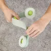 Hands holding a pair of green and white headphones. Produktbild-Vorschau