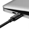 A close-up shot of a black USB-C charging cable plugged into a silver laptop. Anteprima dell’immagine prodotto