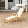 A wooden lounge chair with a canopy is set up on a wooden deck, with a blurred background showing an indoor living space with a beanbag chair. Podgląd zdjęcia produktu