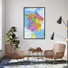 A map of France is displayed on a wall in a living room setting, with chairs and a chessboard nearby. Produktbild-Vorschau