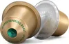 Two coffee capsules are shown against a white background. One capsule is gold with green text and a green center. The other capsule is silver with repeating text. Produktbild-Vorschau