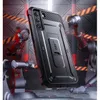 A rugged phone case is displayed in a futuristic, industrial setting with robotic arms. Náhled obrázku produktu