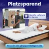 A man is delivering a rolled-up mattress in a box, and a woman is sleeping on a mattress on a bed. Náhled obrázku produktu