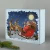 Santa Claus in a sleigh pulled by reindeer, flying through a snowy night sky with a full moon. Produktbild-Vorschau