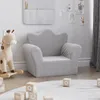 A child's soft sofa in a nursery or play area, with a rocking giraffe toy and alphabet blocks. Anteprima dell’immagine prodotto