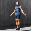 A man is jumping rope in front of a concrete wall. Náhled obrázku produktu