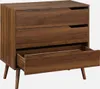 A three-drawer chest of drawers with a wood-like finish and angled legs, shown with the bottom drawer partially open. Produktbild-Vorschau