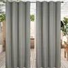 Two gray outdoor curtains hanging in front of a patio or balcony area. Náhled obrázku produktu