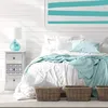 A bedroom scene with a nightstand and bed. Anteprima dell’immagine prodotto