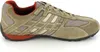 A side view of a single beige and orange athletic shoe against a white background. Produktbild-Vorschau