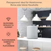 A mini refrigerator is shown on a kitchen counter with decorative elements and text overlays. Produktbild-Vorschau