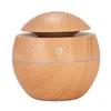 A round, light-colored wooden humidifier with a dome-shaped lid and a silver power symbol. Anteprima dell’immagine prodotto