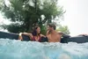 A couple relaxing in an inflatable hot tub outdoors. Náhled obrázku produktu