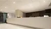 A modern reception area with a long counter and a bar in the background. Anteprima dell’immagine prodotto