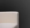 A close-up of a cream-colored couch against a dark background. Produktbild-Vorschau