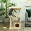 A cat is sitting on a cat tree in a living room setting, next to a large potted plant and a sofa. Anteprima dell’immagine prodotto