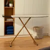An ironing board is set up in a laundry room with shelves of towels and a basket. Produktbild-Vorschau