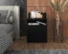 A modern bedroom setting with a black nightstand next to a bed. Podgląd zdjęcia produktu