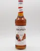 A bottle of Monin Caramel syrup against a white background. Produktbild-Vorschau
