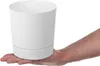 A hand holding a white planter pot. Produktbild-Vorschau
