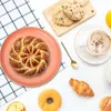 A breakfast spread with bread, cookies, coffee, and a croissant. Produktbild-Vorschau
